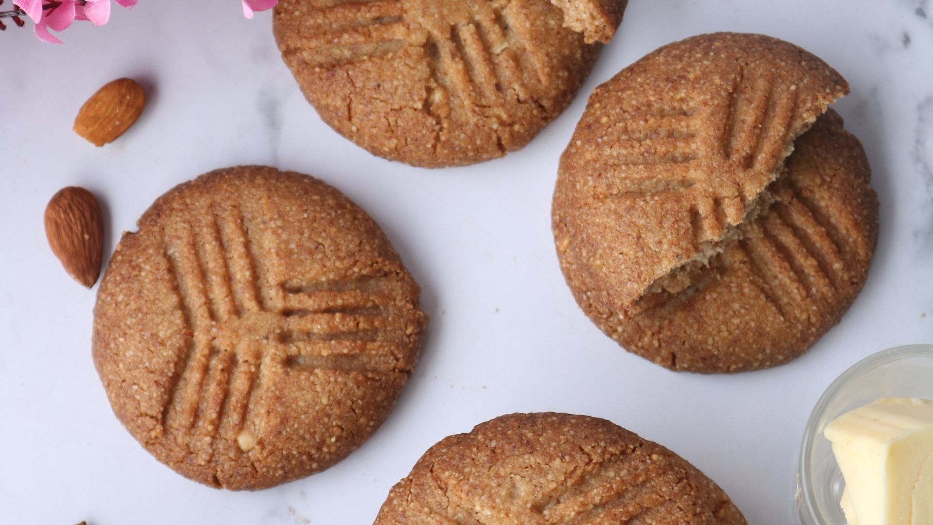 A close up of a cookie with a bite taken out of it on a table.