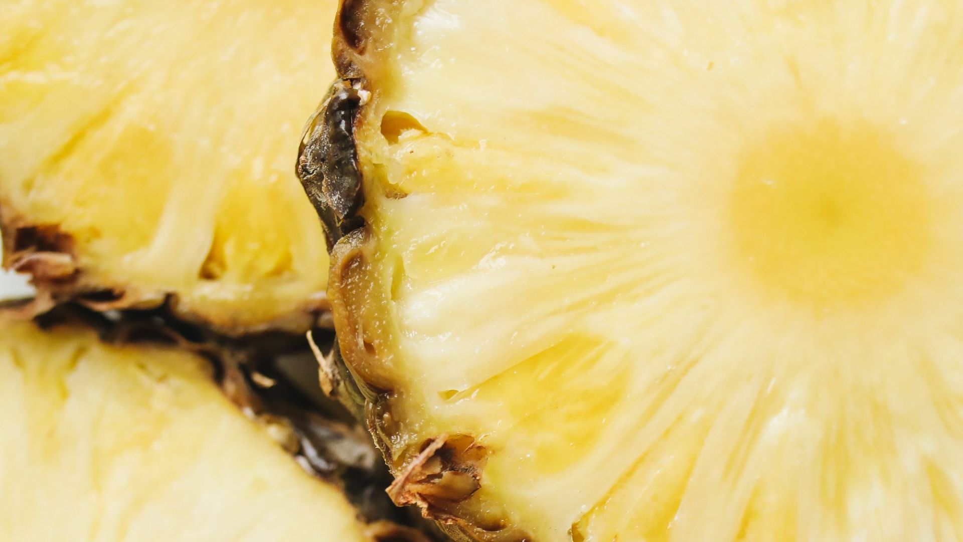 A close up of a pineapple cut in half.