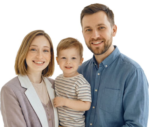 Smiling family of three standing together against a white background, wearing casual clothes.