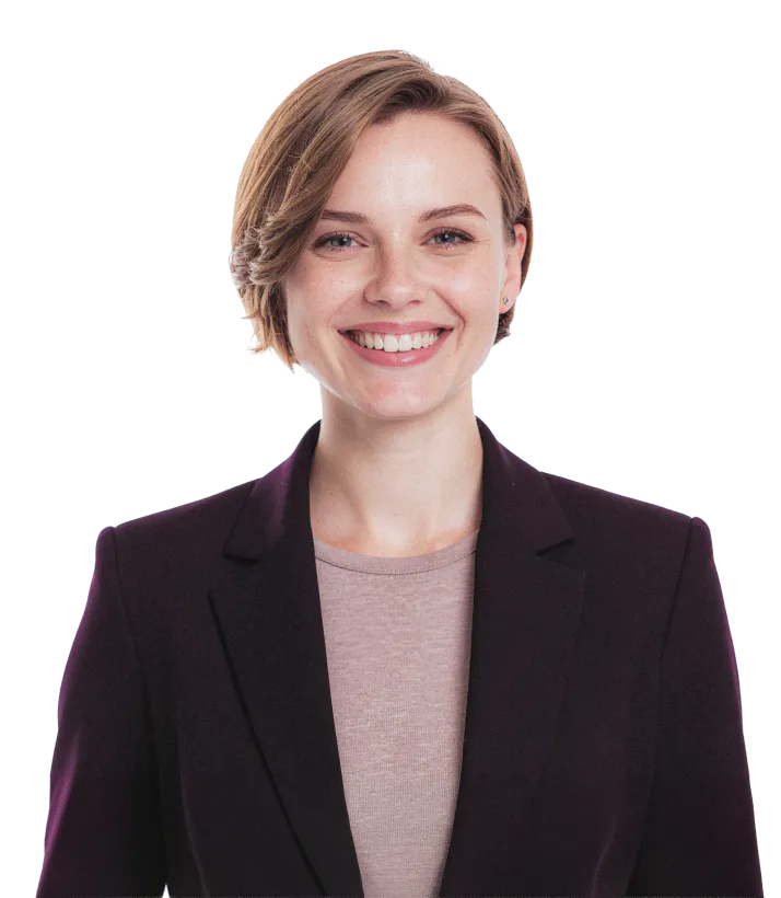 Smiling person in a dark blazer over a light sweater on a white background