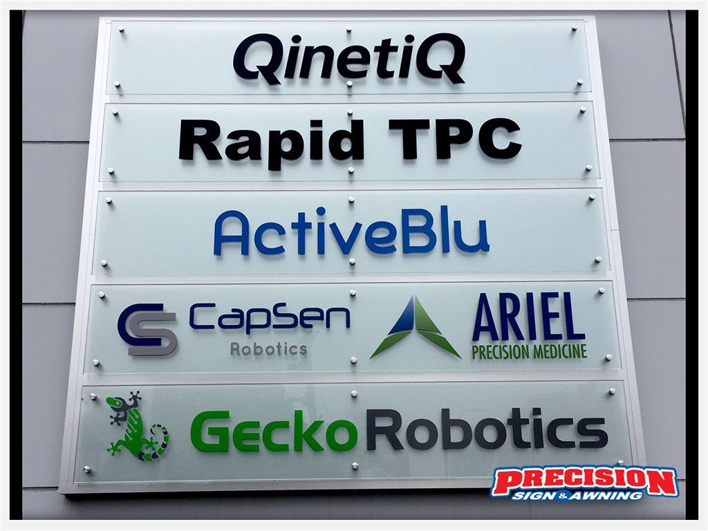 Sign with company names: QinetiQ, Rapid TPC, ActiveBlu, CapSen Robotics, ARIEL, and Gecko Robotics.