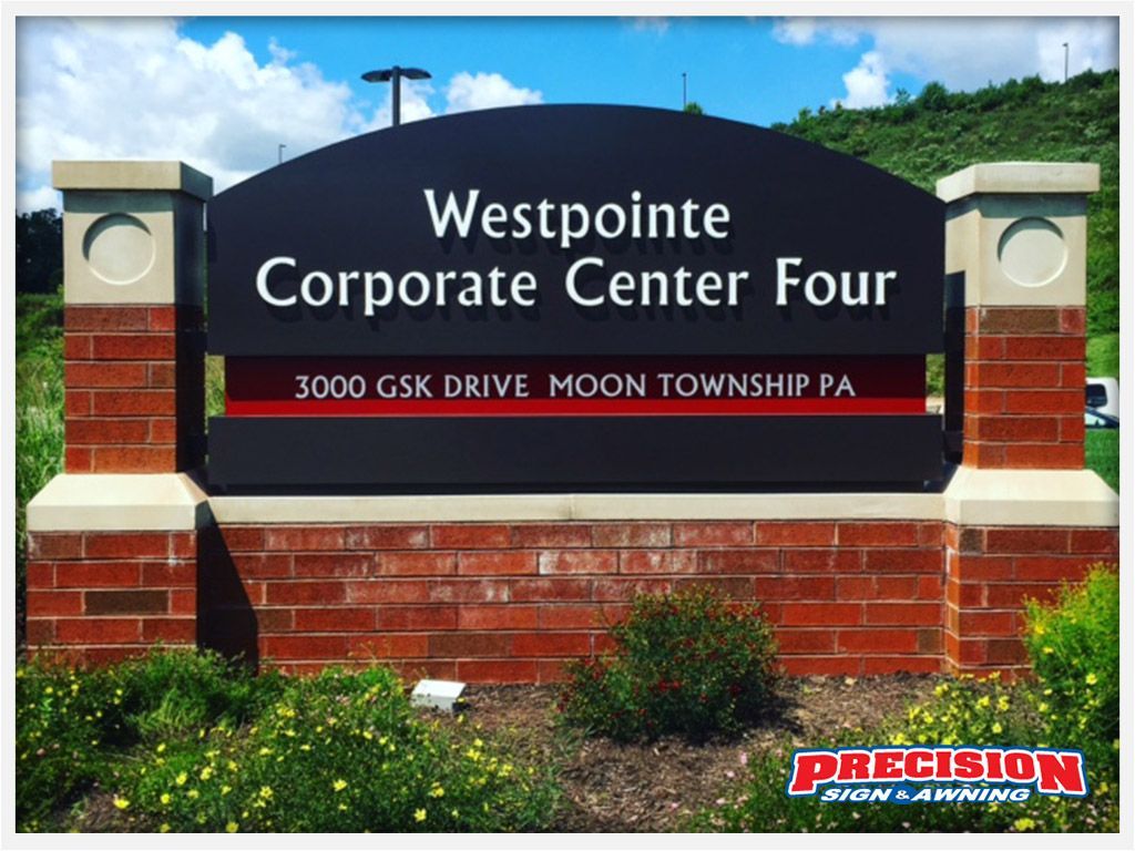 Sign for Westpointe Corporate Center Four, brick and stone with black and red accents, in Moon Township, PA.