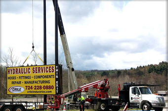 A crane lifting a sign for