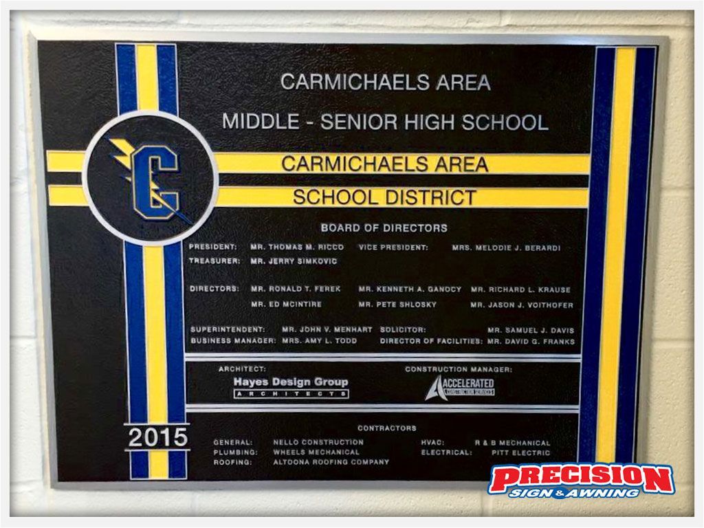 Plaque for Carmichaels Area Middle-Senior High School. Blue, gold, and black with list of board members and date, 2015.