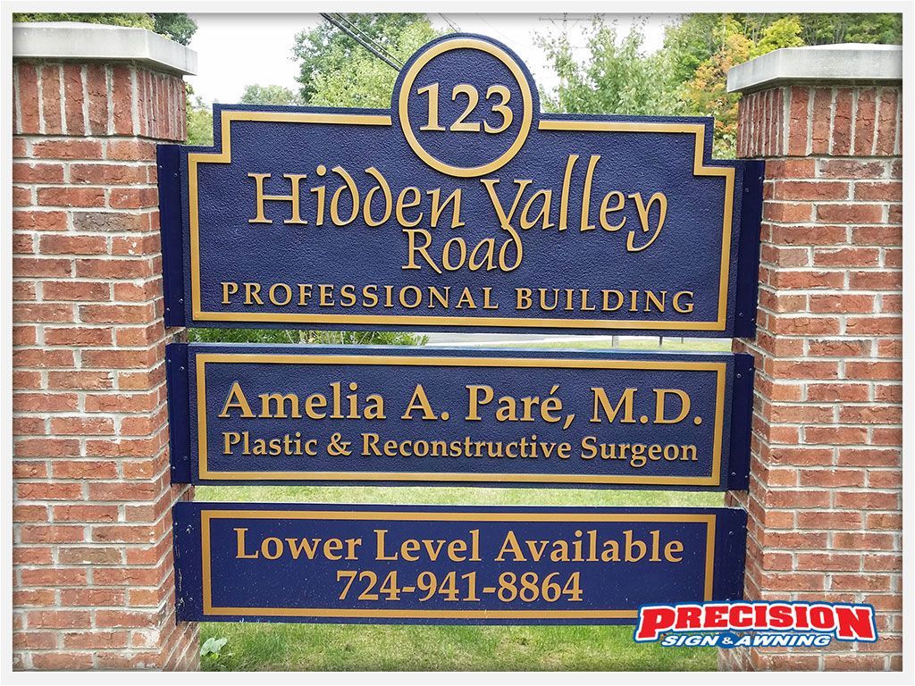 Sign for Hidden Valley Road Professional Building with address and tenant information. Brick columns frame the sign.