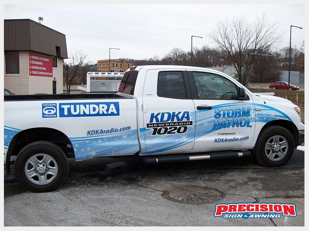 White Toyota Tundra truck with KOKA 1020 radio station branding,