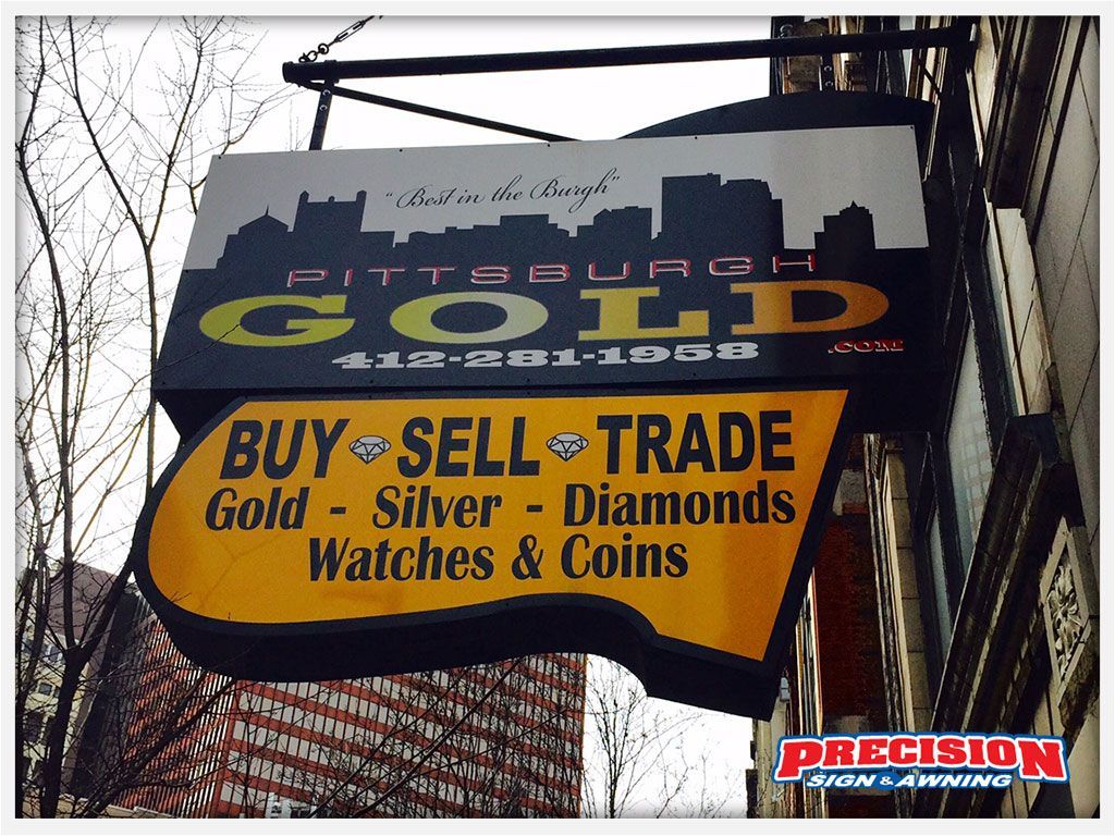 Sign for "Pittsburgh Gold": buy, sell, trade gold, silver, diamonds, watches, and coins. Features Pittsburgh skyline.