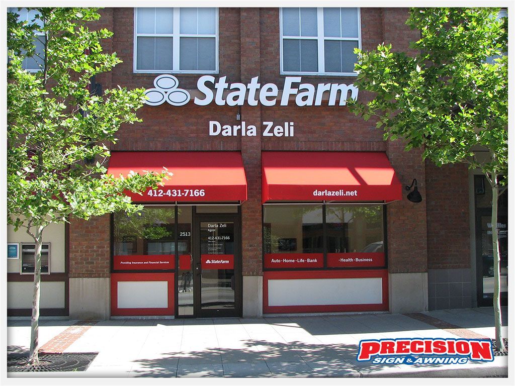 State Farm office with red awnings and signage, Darla Zeli, brick facade.