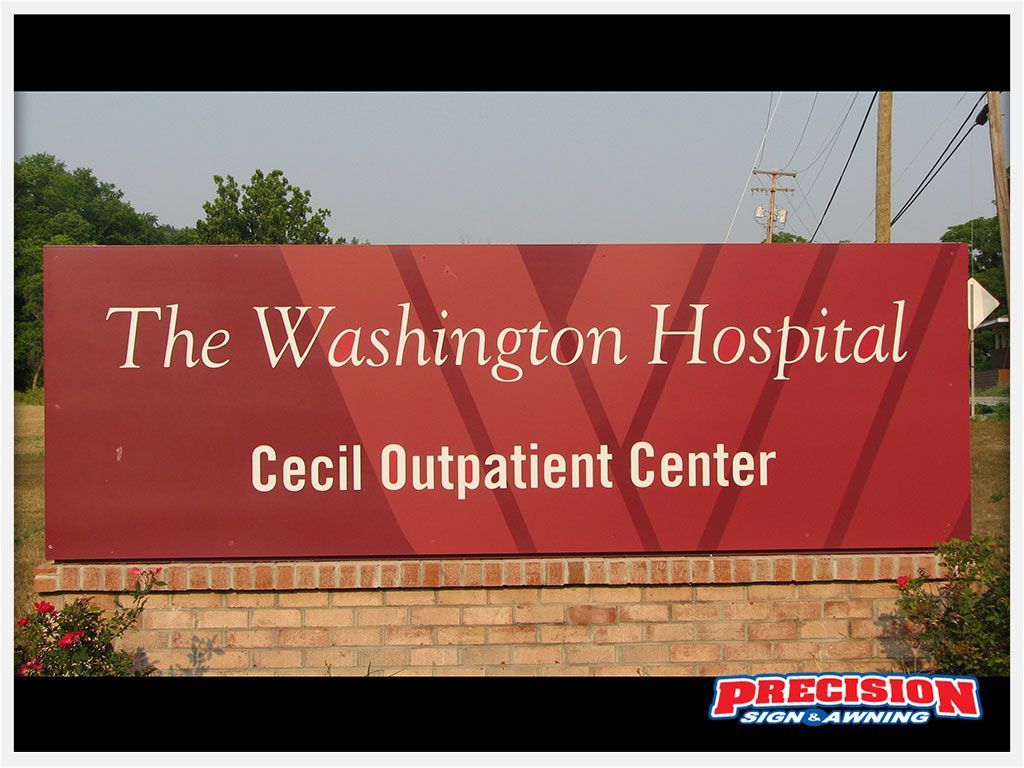 Sign for The Washington Hospital Cecil Outpatient Center; maroon background, white text.
