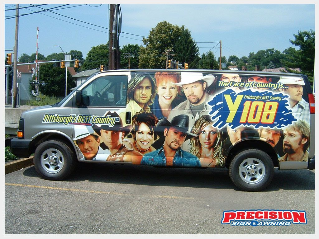 Gray van with Y108 radio station logo and country music star portraits. Parked outdoors.