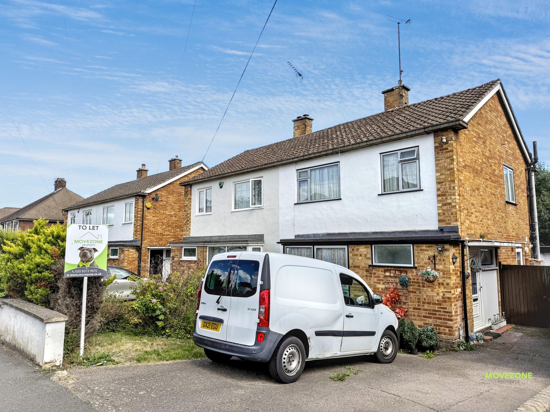 Semi-detached brick house with a white van parked in the driveway on a residential street.