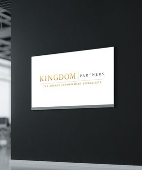 Dark wall sign with a gold crown logo and the words “Kingdom Growth Partners” on a navy background