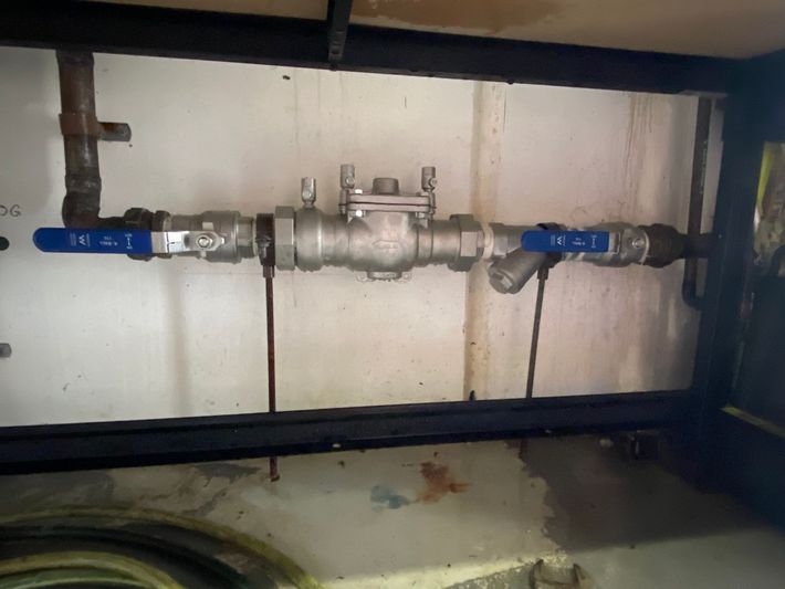 Blue-handled Valve Assembly on a Wall-mounted Pipe — Gibson Plumbing & Roofing Pty Ltd in Gladstone Central, QLD