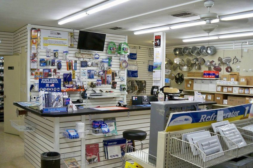 A store with a counter and a sign that says refrigerator on it.