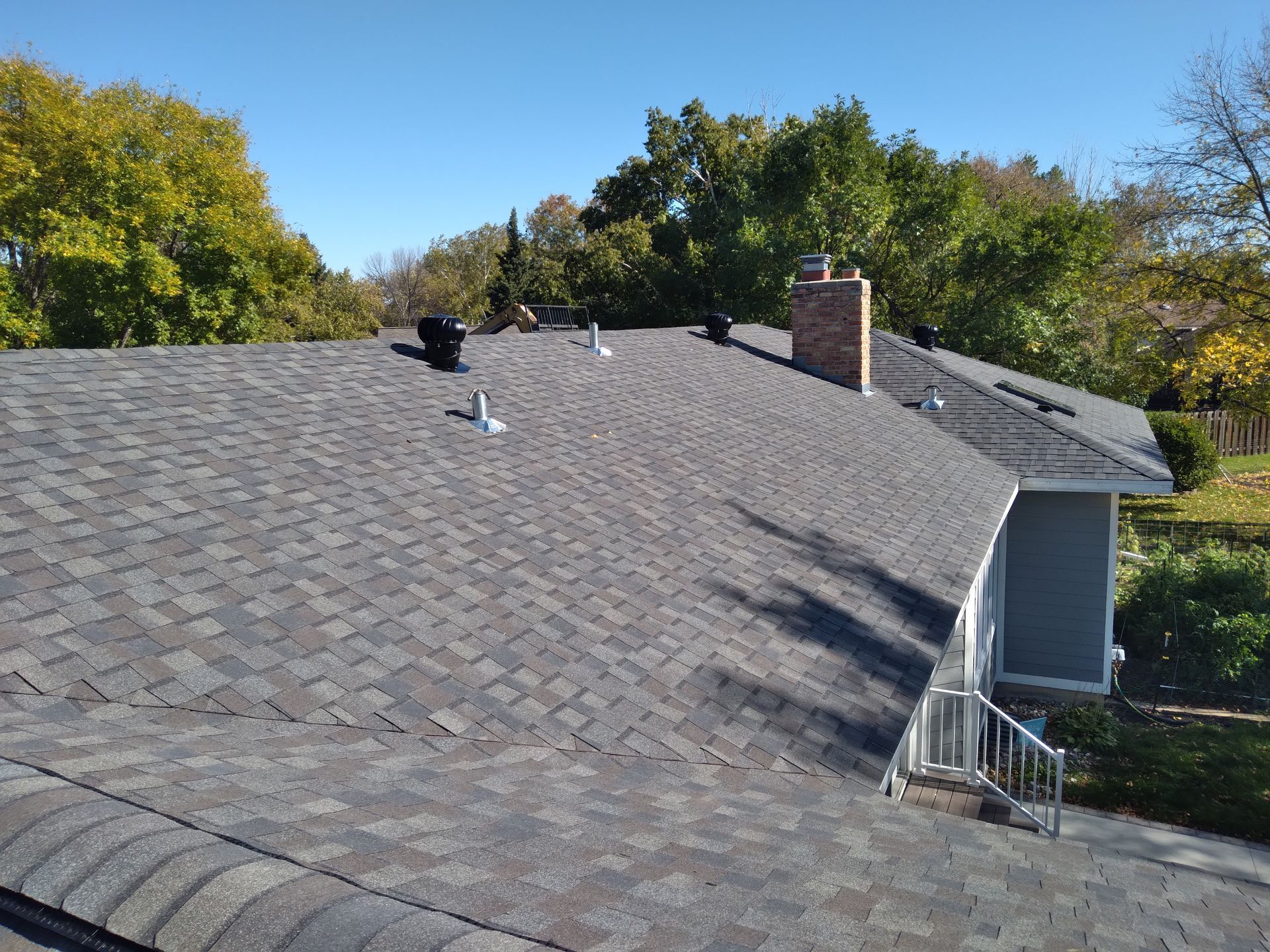 Roof Shingles, Turbines and Ridge Vents with a Velux Skylight replaced after an insurance hail damage claim in Moorhead, Mn