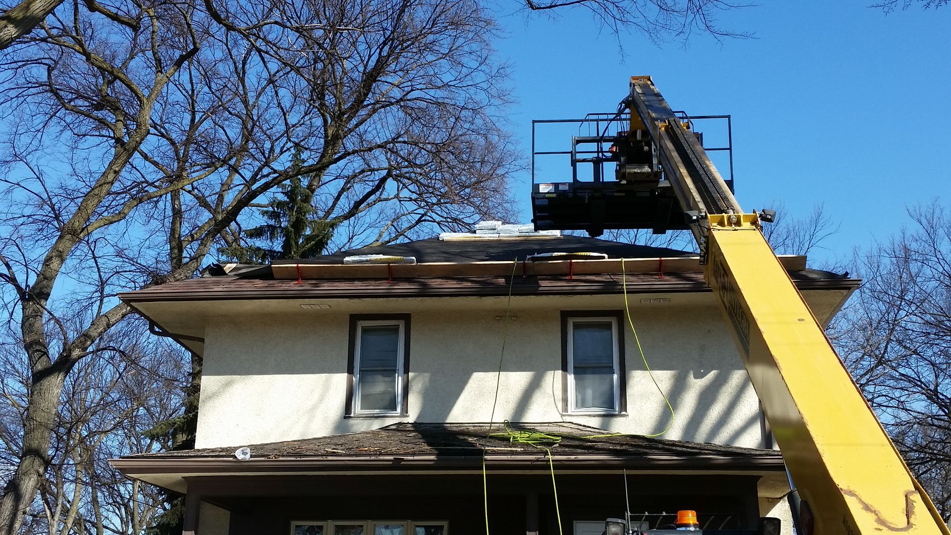 Roof Safety Jack Planks and Bundles of new fiberglass shingles on 2nd Story of a House near the Fargo-Moorhead Metro Area