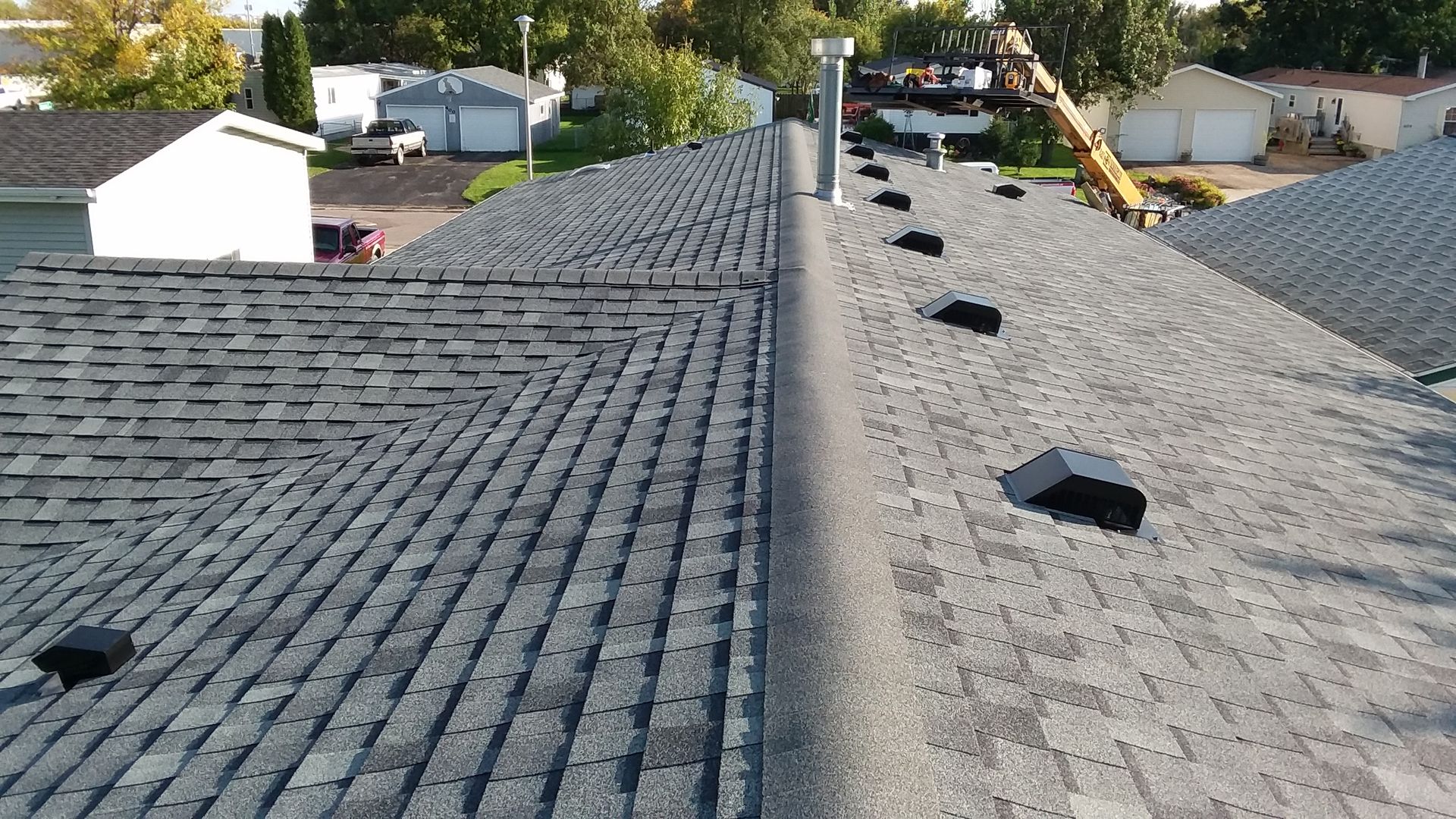 Roofer tools, underlayment and bundles of shingles with a minimum of 6-inches between shingle courses near Casselton, ND