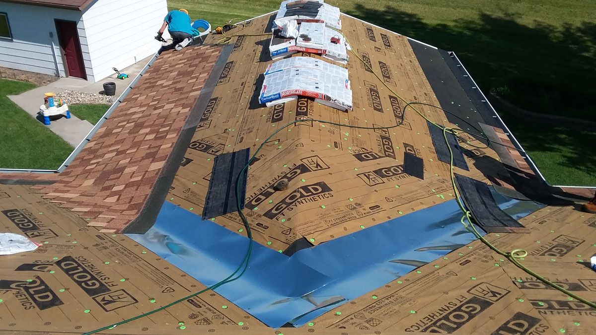 A Fergus Falls Minnesota roofer installing shingles, metal in valleys, synthetic felt and ice & water barrier on a sunroom