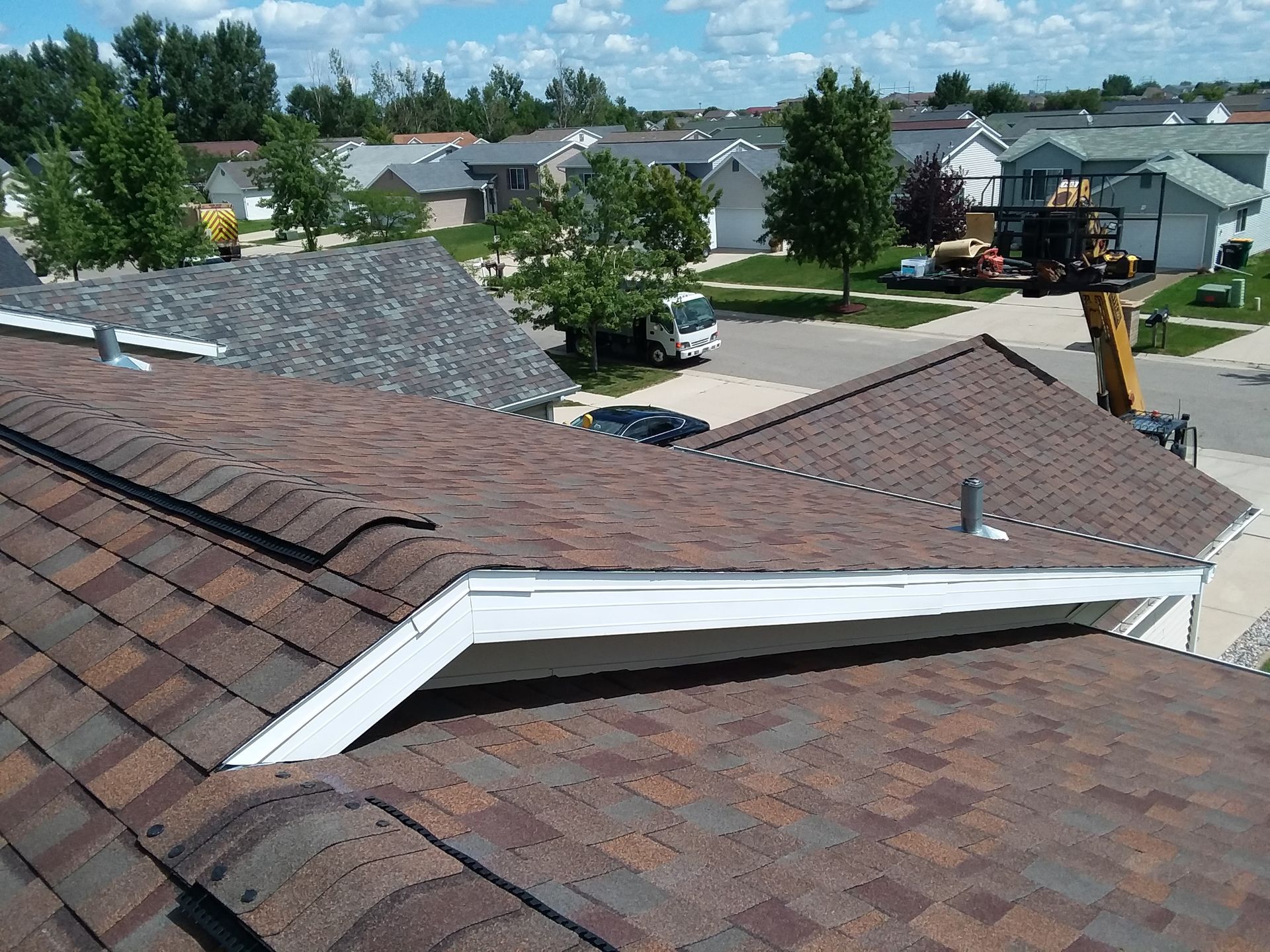 Heatherblend colored CertainTeed Class 4 composite shingles installed with a low-profile ridge vent near Moorhead-MN