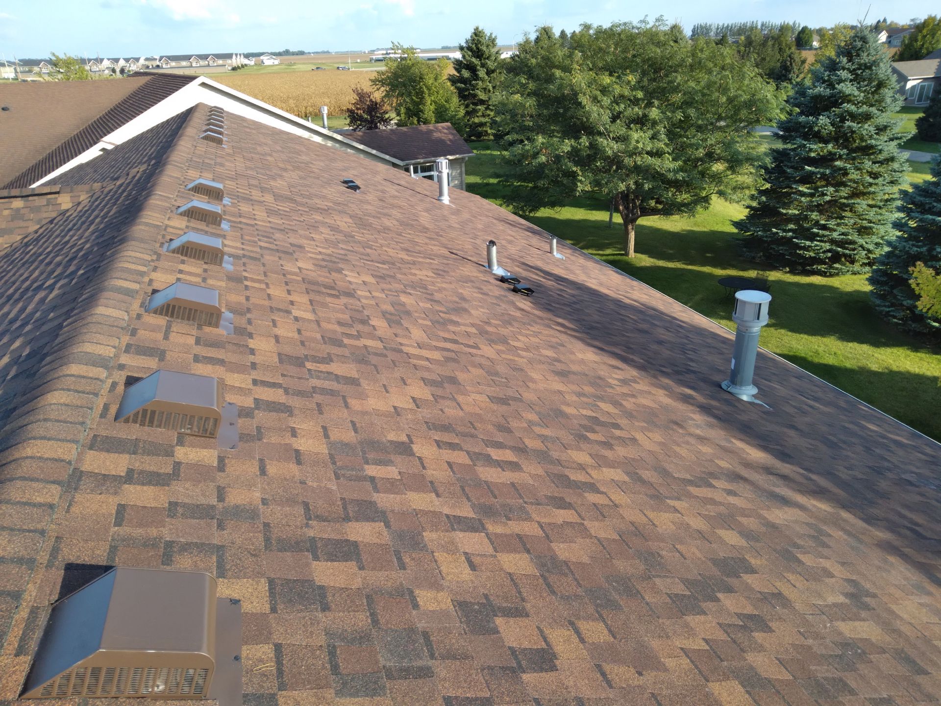 MaxDef Burnt Sienna colored CertainTeed asphalt shingles with brown slant back roof vents installed near Barnesville, MN