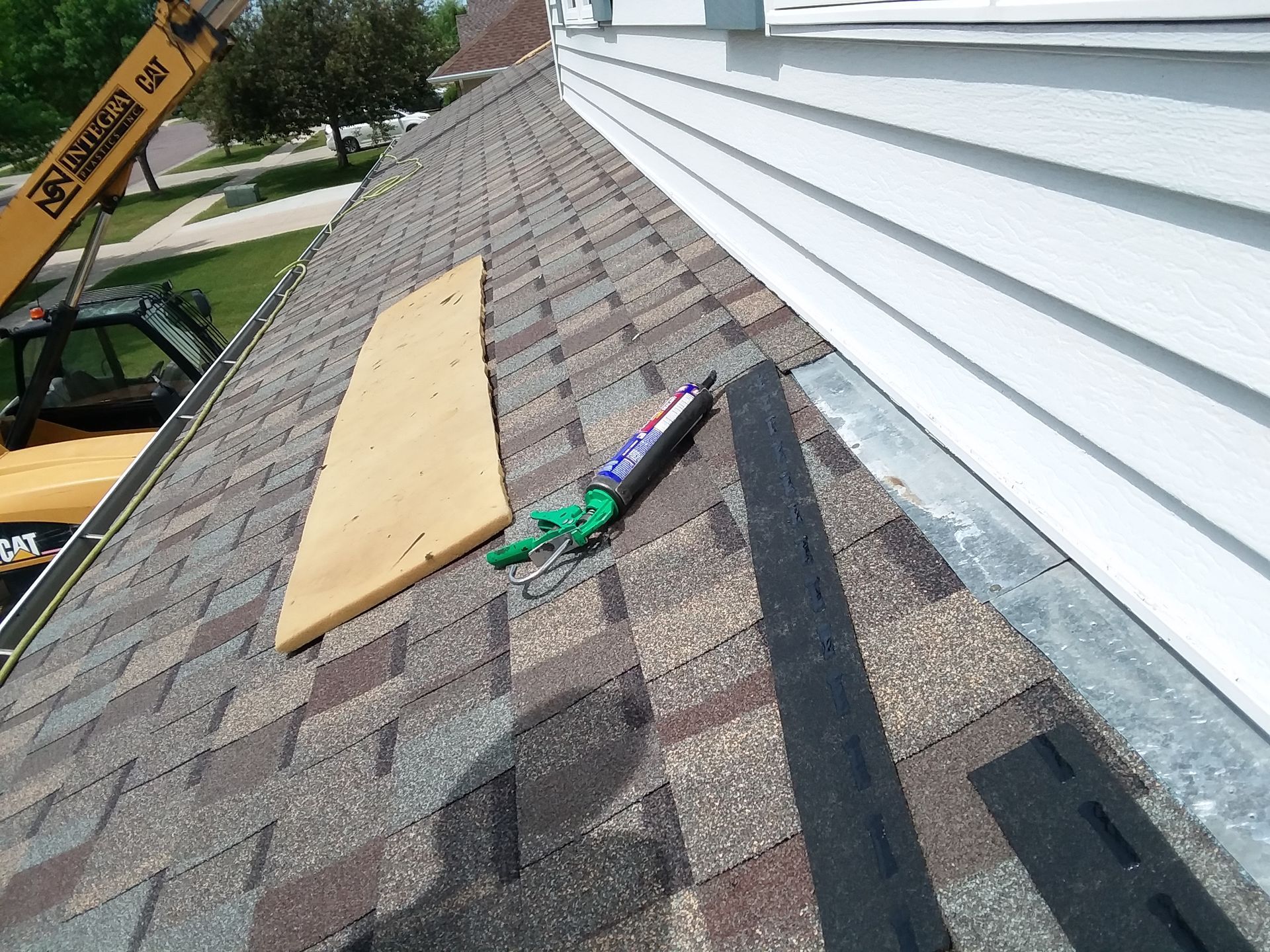 CertainTeed Northgate Weathered Wood shingle beauty strips being installed on roof to wall flashing in Pelican Rapids, MN