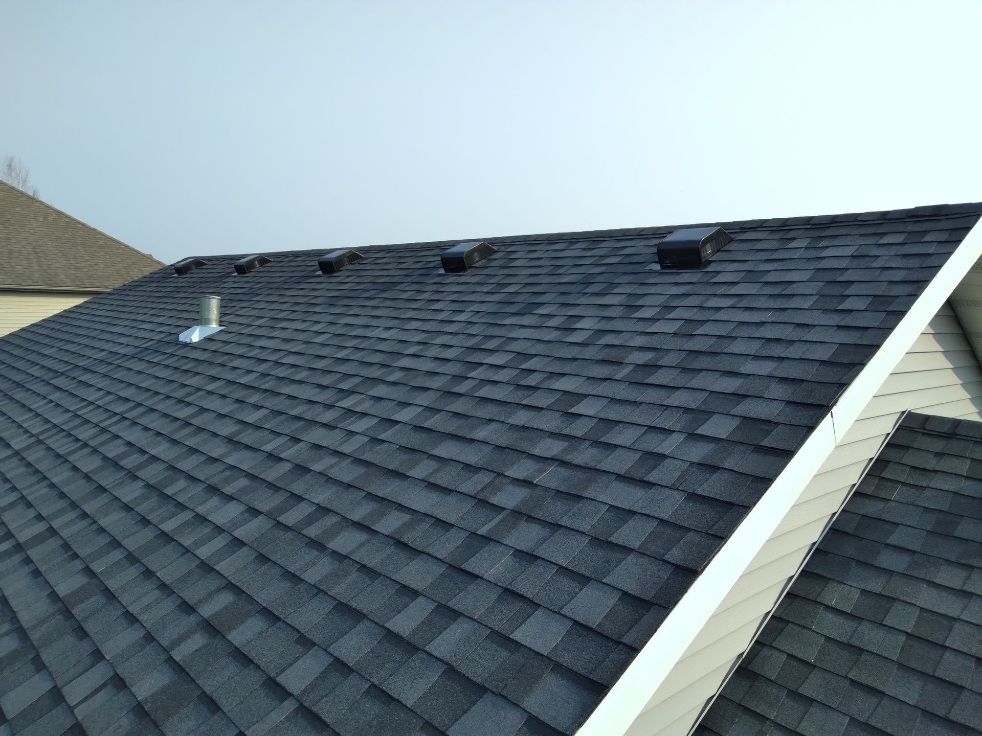 Valley City area roof completed with  Landmark PRO Moire Black colored shingles using slant back exhaust ventilation
