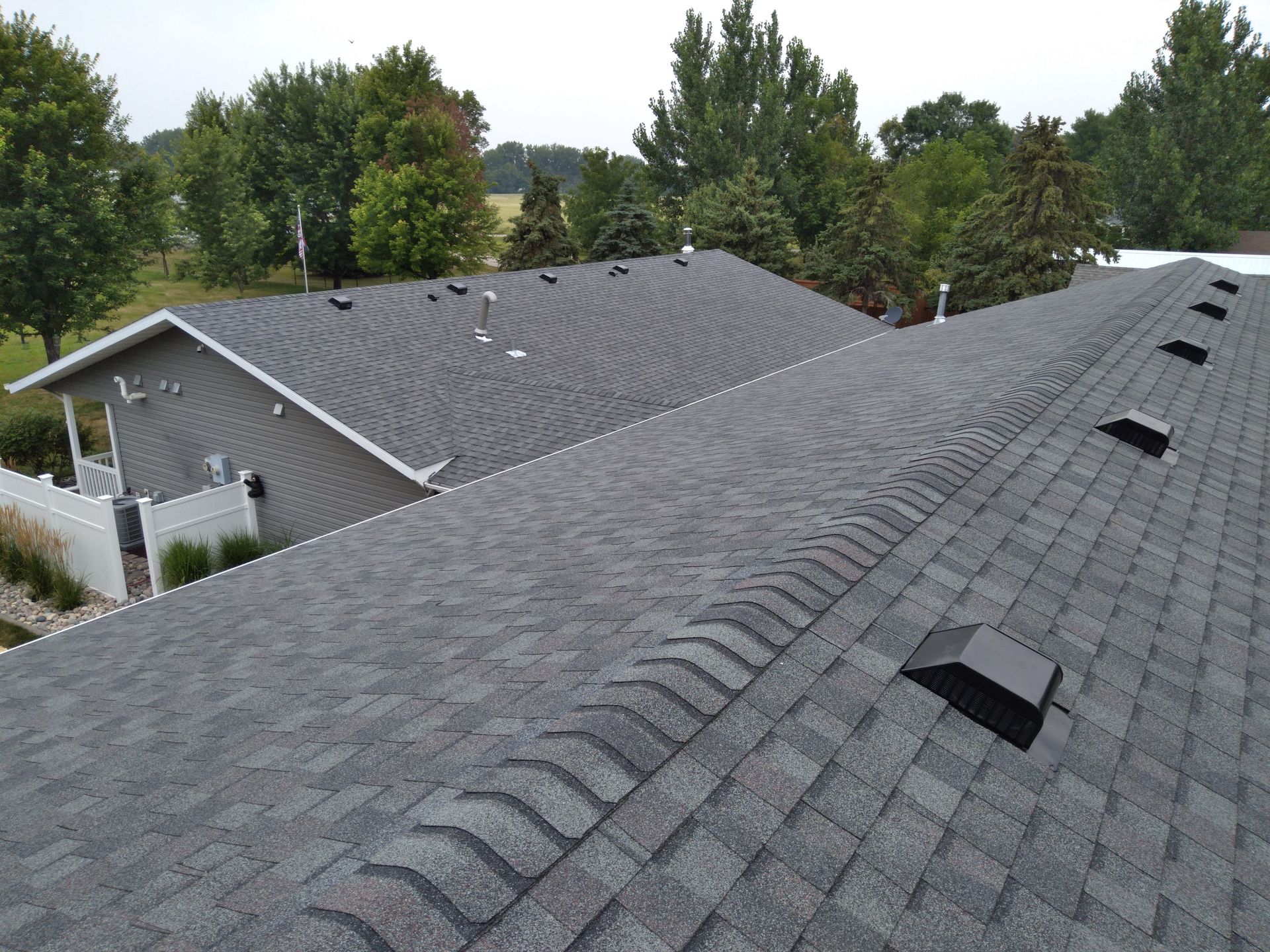 A class 3 impact rated roof replacement on a house, breezeway, and garage with slant back ventilation near Fergus Falls, MN