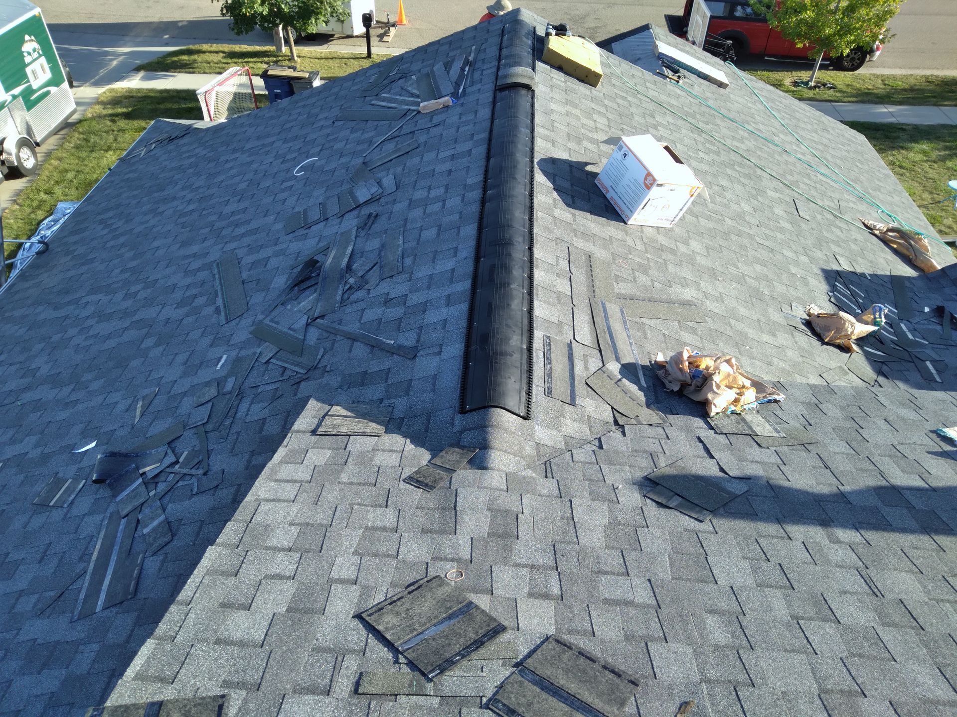 Barnesville, Minnesota roofers installing a class 3 impact rated roofing material and a shingle over low profile ridge vent