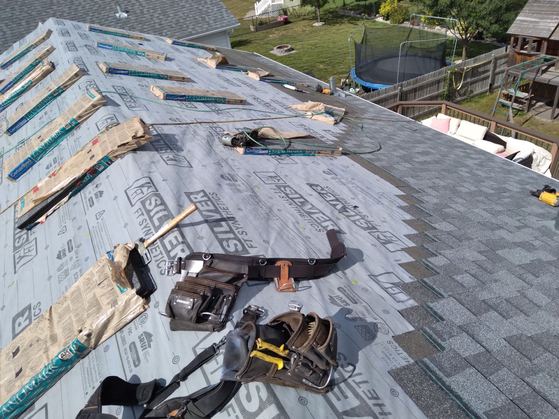 Roofer tools, underlayment and bundles of shingles with a minimum of 6-inches between shingle courses near Casselton, ND