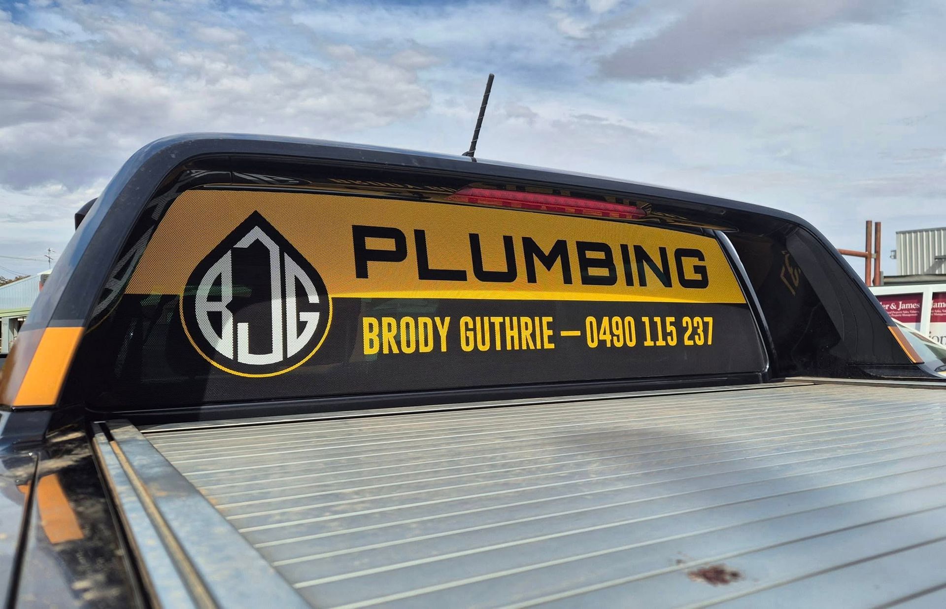 Brody Guthrie Plumbing truck window sign with logo and contact info — BJG Plumbing in Coolamon, NSW