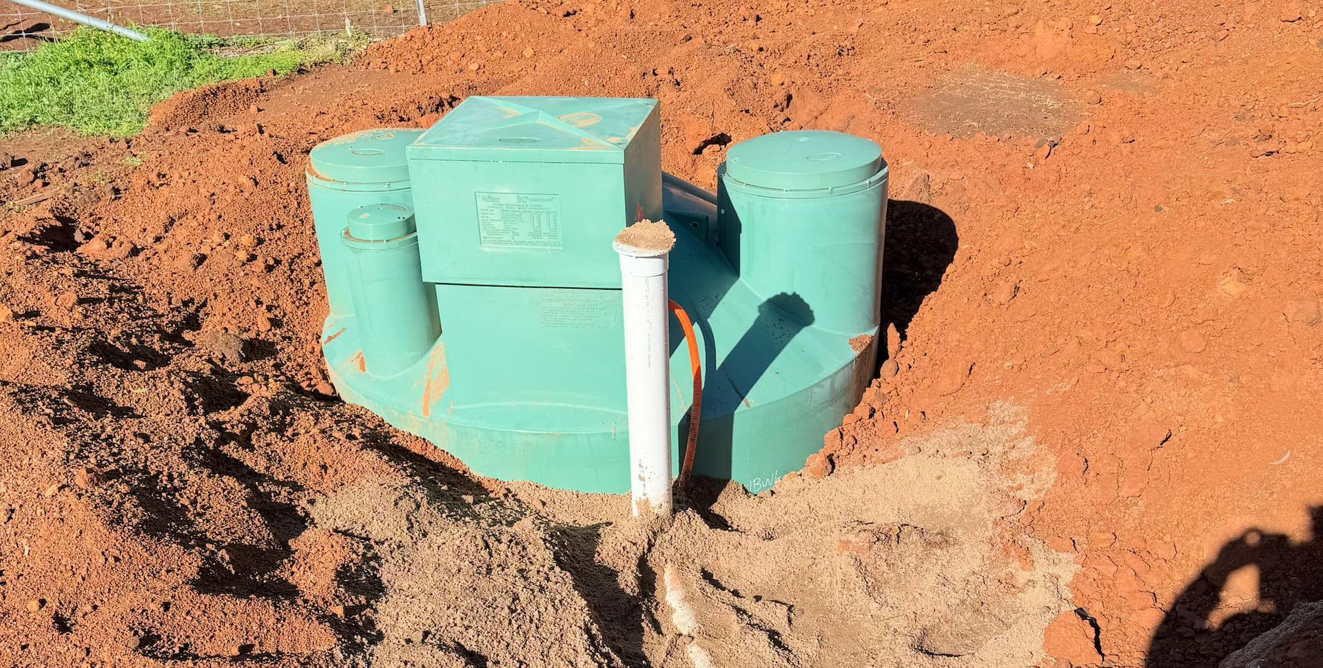 Septic Tank Installation With Blue Pipes And Tanks In Soil Excavation — BJG Plumbing in Coolamon, NSW