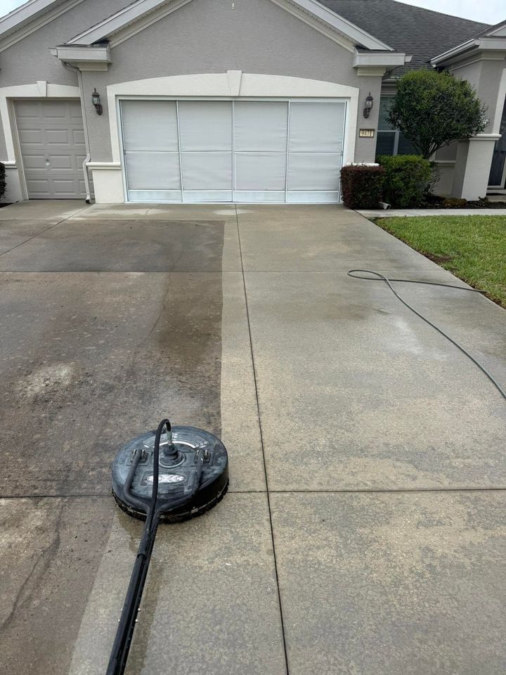 Suburban driveway with a driveway marker and a house with closed white garage doors