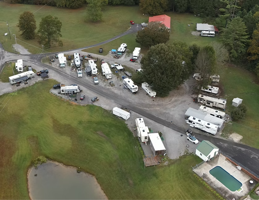 An aerial view of a rv park with a swimming pool.
