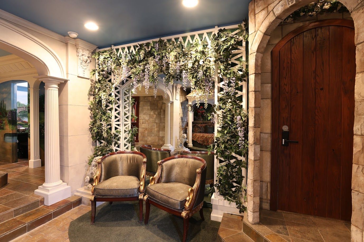 Two chairs are sitting in a room with a wooden door.