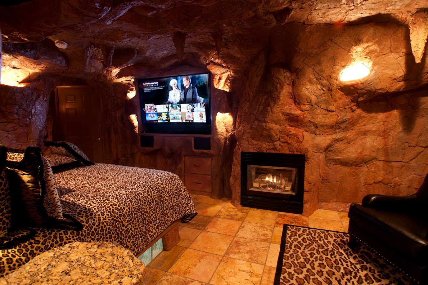 A bedroom with two beds and a flat screen tv