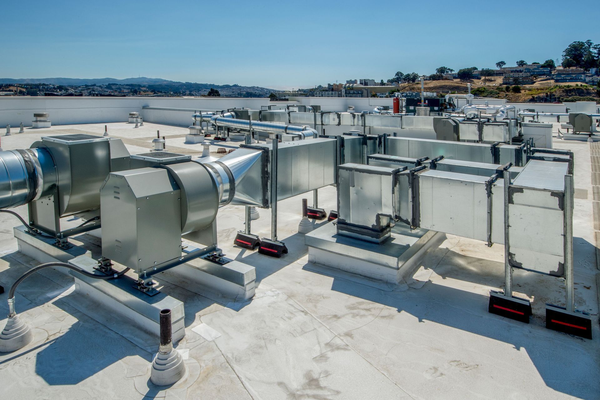 A rooftop with a lot of pipes and fans on it