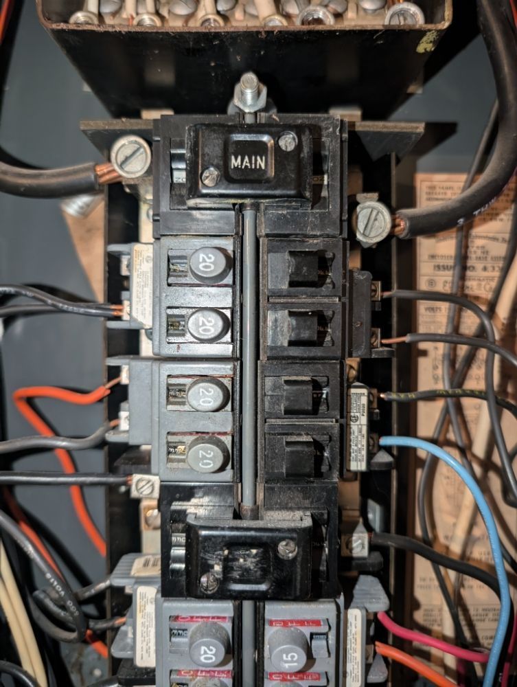 Electrical panel with circuit breakers and main power switch.