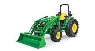 a green john deere tractor with a front loader on a white background .