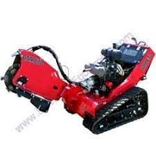 a red stump grinder with tracks on a white background .