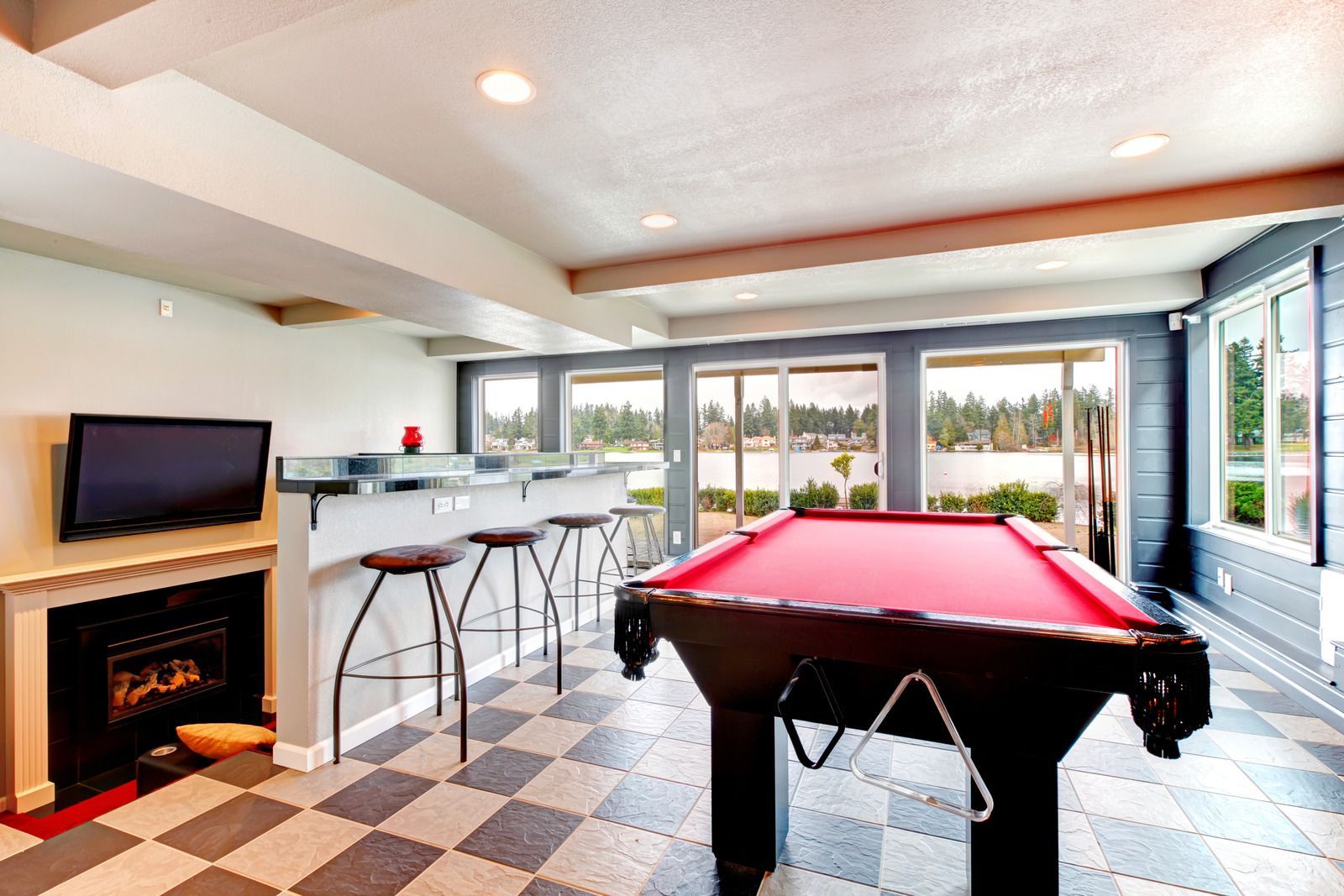 There is a pool table in the middle of the room.