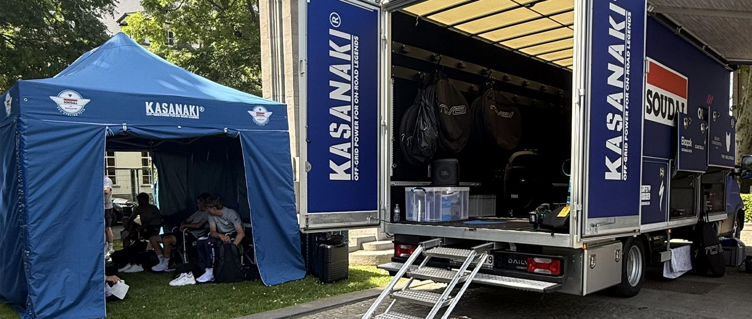 Kasanaki trailers with open sides on grass, showing mounted equipment inside