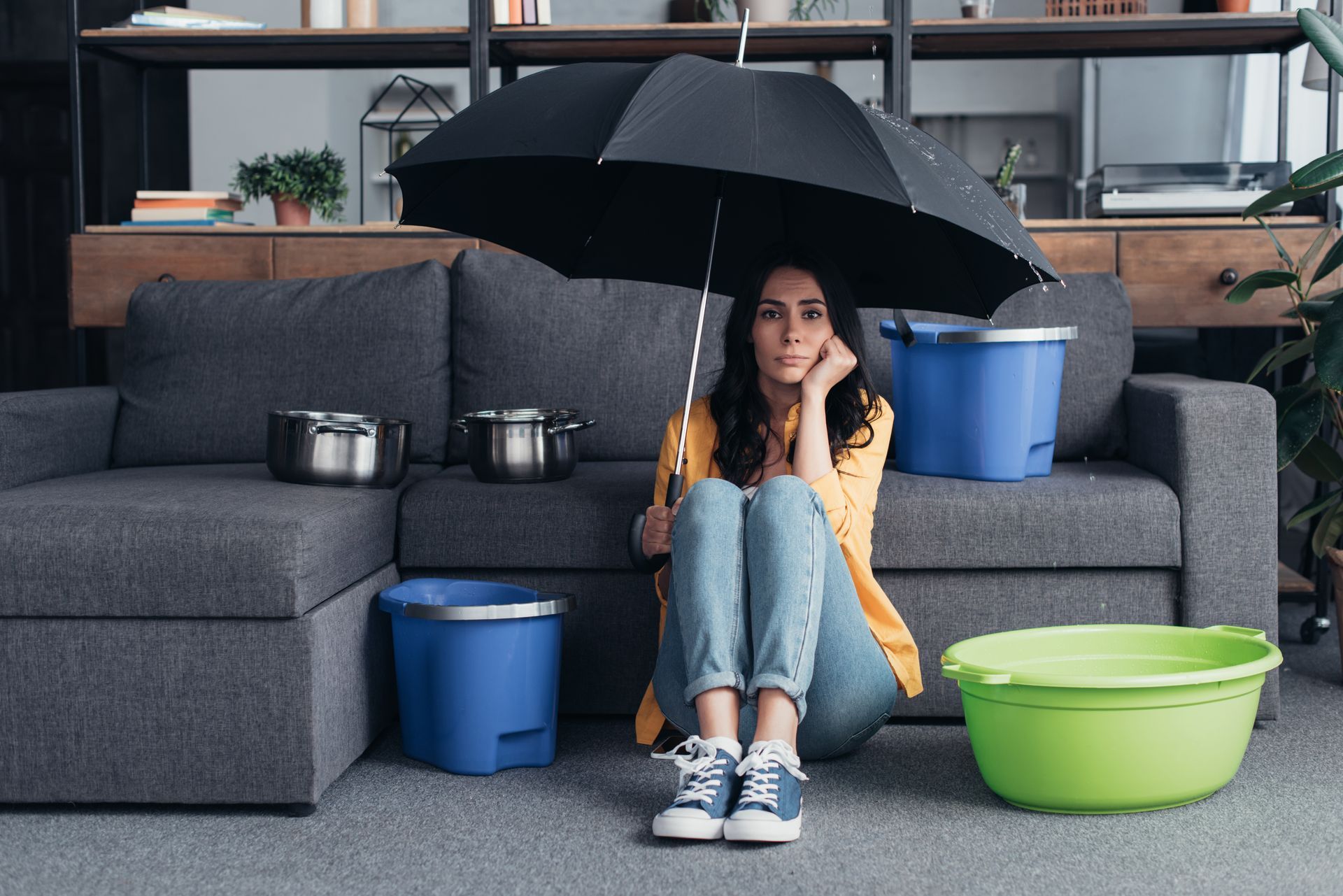 woman with umbrella leaking roof