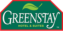 GreenStay Hotel & Suites logo on a green and red sign background
