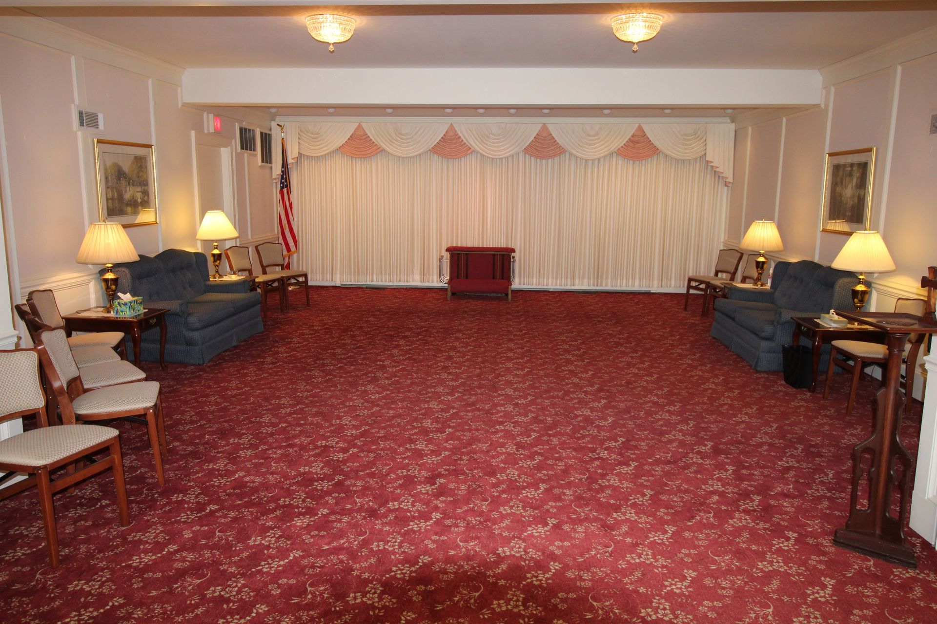 A large room with a red carpet and lots of furniture