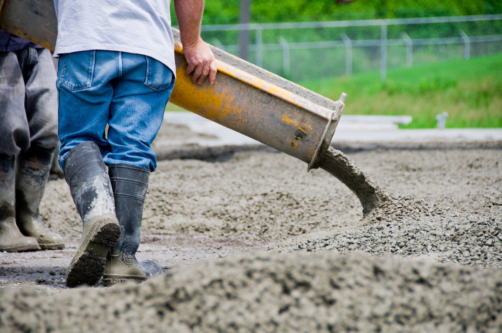 Concrete delivery company pouring ready-mix concrete