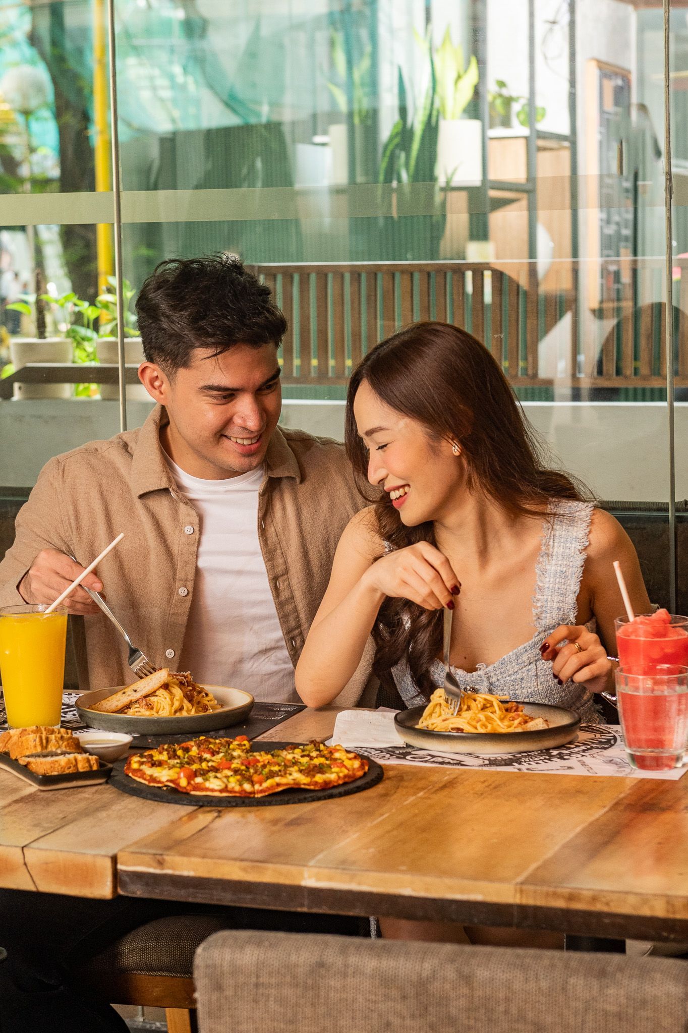 Couple enjoying pasta and pizza at The Picasso Boutique Residences Makati