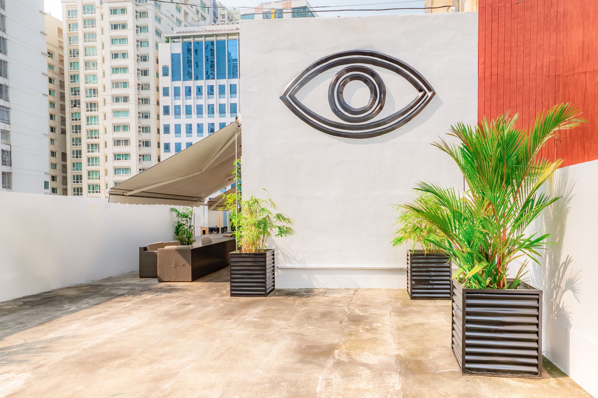 Rooftop terrace with eye wall art at Picasso Boutique Residences Makati