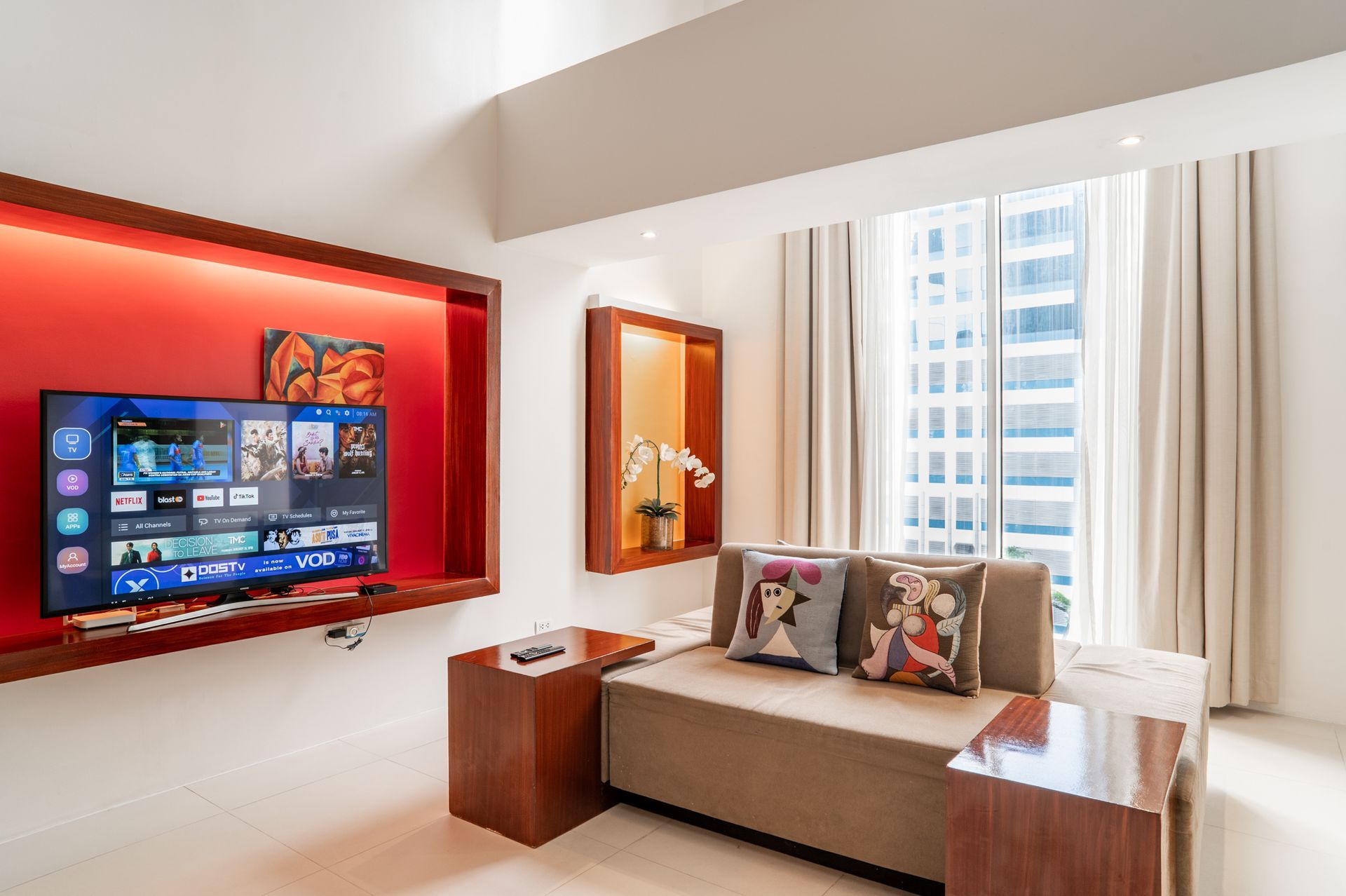 A living room with a couch and a flat screen tv