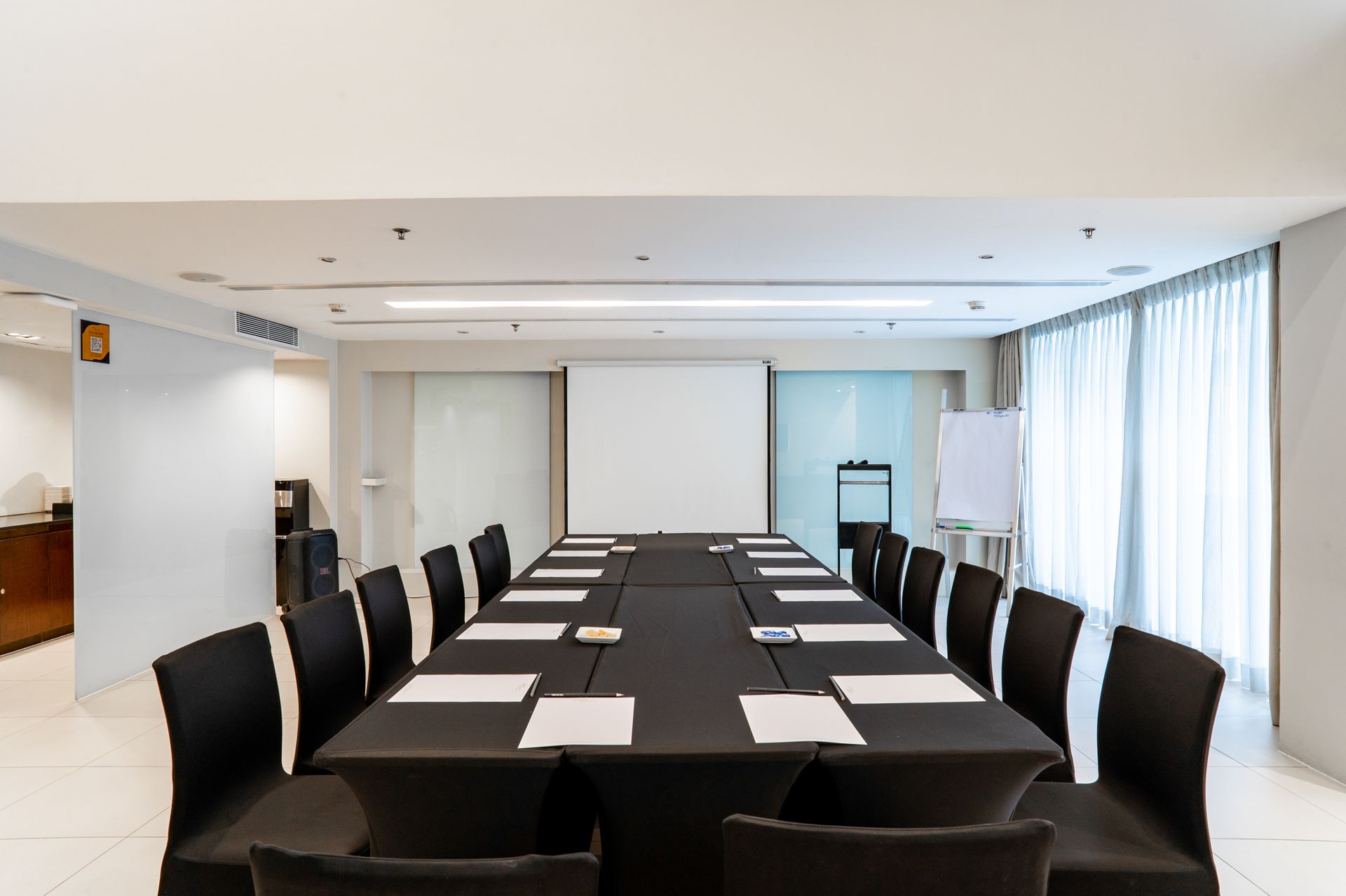 A conference room with a long table and chairs