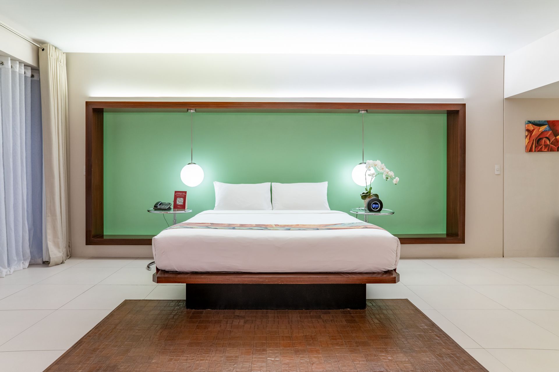 Spacious bedroom with green accent wall